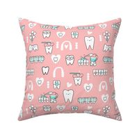 Pink Dentist and Orthodontics medicine fabric pattern with invisible braces, water floss irrigation, toothbrush. Oral hygiene design.