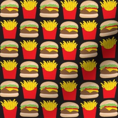 medium cheeseburger and fries on black