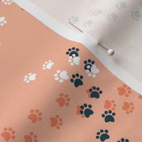 Small scale // Hot dogs chase // flesh coral background navy blue and white paw prints