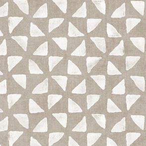 Block Print Triangles on Ecru (large scale) | Pinwheel triangles from hand carved block, white on sandy beige.