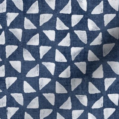 Block Print Triangles on Blue Grey Denim (large scale) | Pinwheel triangles from hand carved block, white on faded denim.