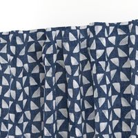 Block Print Triangles on Blue Grey Denim (large scale) | Pinwheel triangles from hand carved block, white on faded denim.