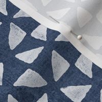Block Print Triangles on Blue Grey Denim (large scale) | Pinwheel triangles from hand carved block, white on faded denim.