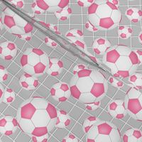pink and white soccer balls w goal net detail on gray