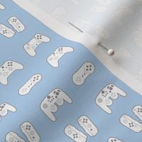 Game Controllers on Pastel Blue