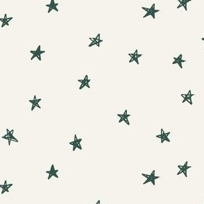 Green christmas stars on bone festive fabric by Erin Kendal