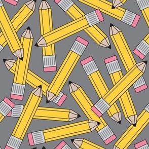 large yellow pencils on grey