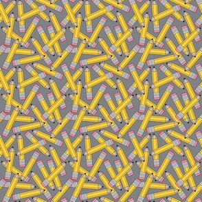 small yellow pencils on grey