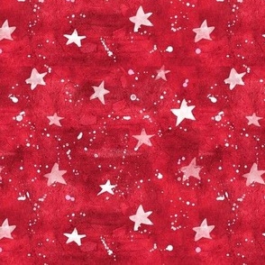 Watercolor stars and paint splatters on red