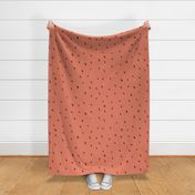 sparse dots brown on muted coral 
