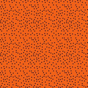 tiny black dots on orange