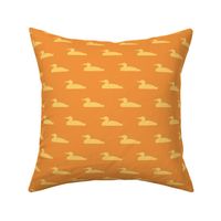 Small abstract loon silhouette - sunrise gold on orange