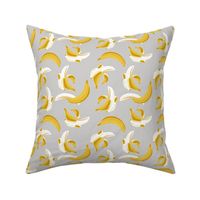 Small scale // Flying bananas // grey background yellow fruit