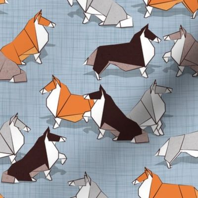 Small scale // Origami Collie friends // pastel blue linen texture background white orange & brown paper and cardboard dogs