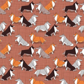 Tiny scale // Origami Collie friends // brown siena linen texture background white orange & brown paper and cardboard dogs