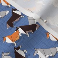 Tiny scale // Origami Collie friends // denim blue linen texture background white orange & brown paper and cardboard dogs
