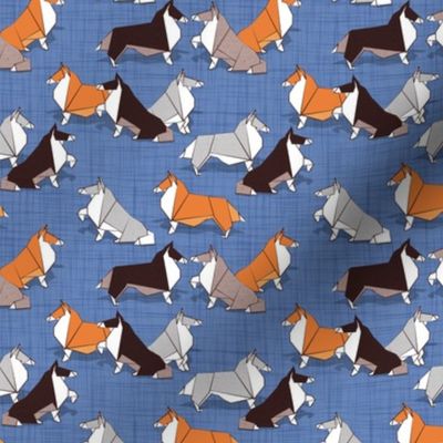 Tiny scale // Origami Collie friends // denim blue linen texture background white orange & brown paper and cardboard dogs