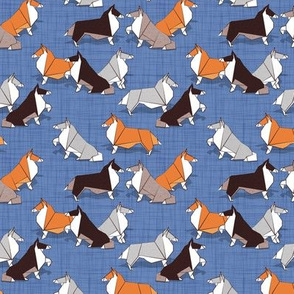 Tiny scale // Origami Collie friends // denim blue linen texture background white orange & brown paper and cardboard dogs