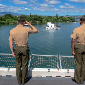 70-14 Two Marines render salutes to the the USS Arizona Memorial upon entering Pearl Harbor.