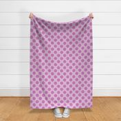 Magenta polka dots with stitch-like details on a pink fabric texture.