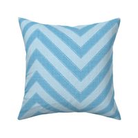 Dynamic blue chevron pattern with a playful, structured energy.