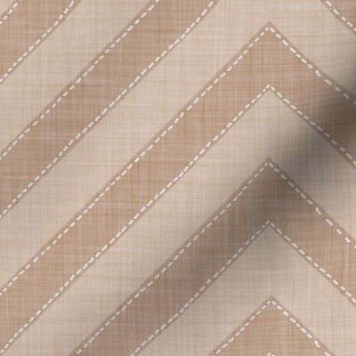 Beige chevrons with dotted outlines on cream offer a calm, handcrafted look.