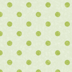 A whimsical spread of lime polka dots on a textured pale green backdrop