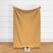 Warm orange chevrons weave a lively zigzag pattern with a cozy, textured appeal.