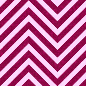 Chevrons in shades of magenta interlock in a velvety zigzag, blending energy with harmony.