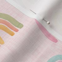 watercolor pastel scattered rainbows on pink linen