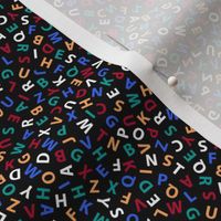 tiny ditsy colorful alphabet on black