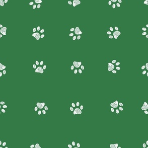 White doodle paw prints with green background seamless pattern