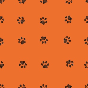Black doodle paw prints with orange background seamless pattern. Happy Hallooween background