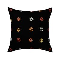 Orange  yellow and white doodle paw prints with black background seamless pattern. Happy Hallooween background