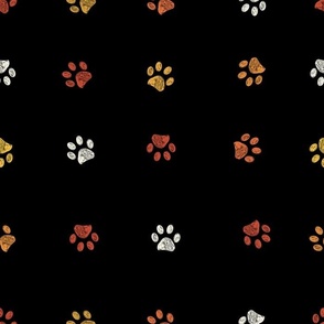 Orange  yellow and white doodle paw prints with black background seamless pattern. Happy Hallooween background