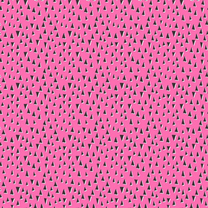 Scattered modern triangles on pink