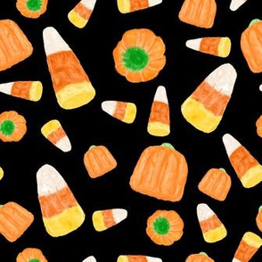 candy corn and pumpkins on black