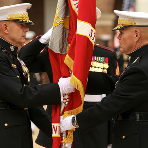 97-18 General Robert B. Neller, 37th Commandant of the Marine Corps, passes the Marine Corps Battle Color to Gen. David H. Berger, 38th Commandant of the Marine Corps 