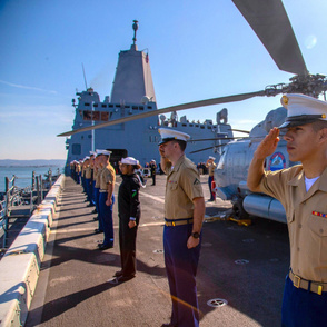  99-18 U.S. Marines and Sailors salute as they man the rails of the USS Somerset 