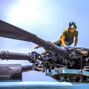100-1    A U.S. Marine with Marine Heavy Helicopter Squadron 463performs Maintenance on a CH-53E Sea Stallion