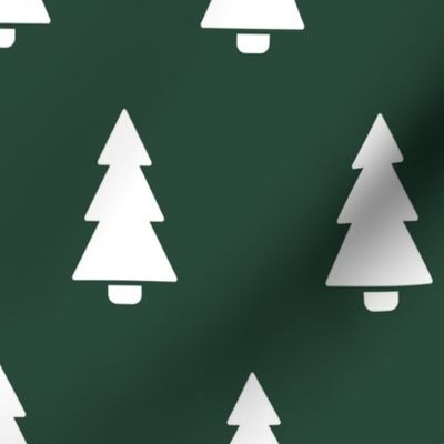 White silhouette Christmas trees on green