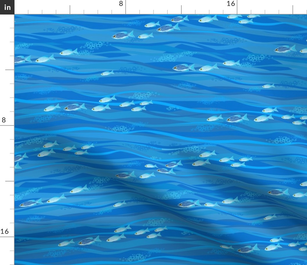 Blue pattern with waves and small fish.