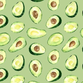 halves avocado on a green background green