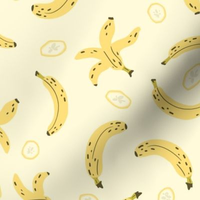 Banana, peel and slices on yellow
