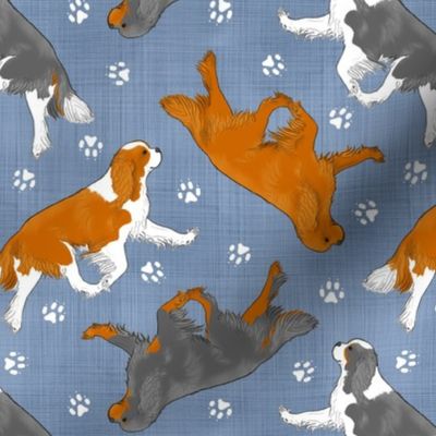 Trotting Cavalier King Charles Spaniels and paw prints - faux denim