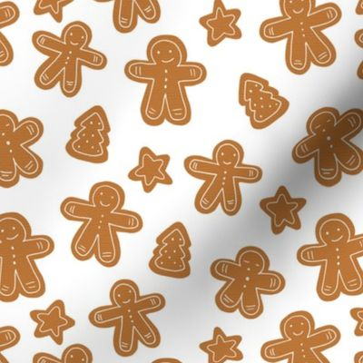 Little Christmas cookies and gingerbread men caramel brown on white