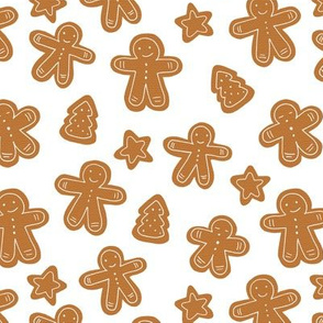 Little Christmas cookies and gingerbread men caramel brown on white
