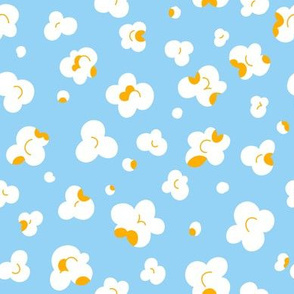 Popcorn flakes on light blue background