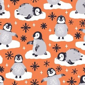 Cute penguins. Orange background