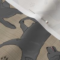 Trotting black Labrador Retrievers and paw prints - faux linen